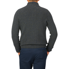 A person wearing a Gran Sasso green melange wool quarter button sweater and navy pants, shown from the back against a plain light gray background.