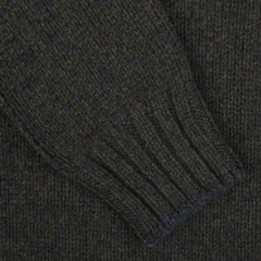 Close-up of a Green Melange Wool Quarter Button Sweater sleeve by Gran Sasso, crafted from luxurious merino wool, featuring ribbed detailing at the wrist.