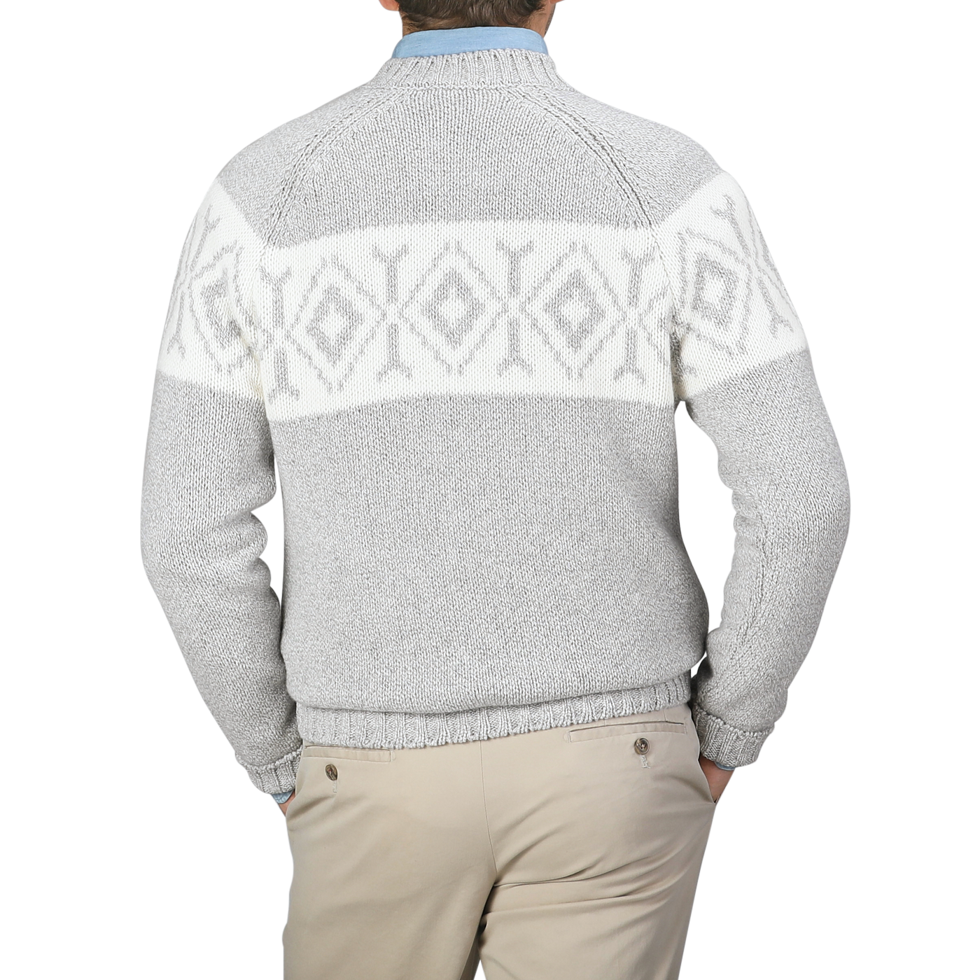 A person wearing a Gran Sasso Grey Eco Cashmere Norwegian Crewneck Sweater, featuring a white geometric pattern on the back, pairs it with beige pants and stands against a plain background.