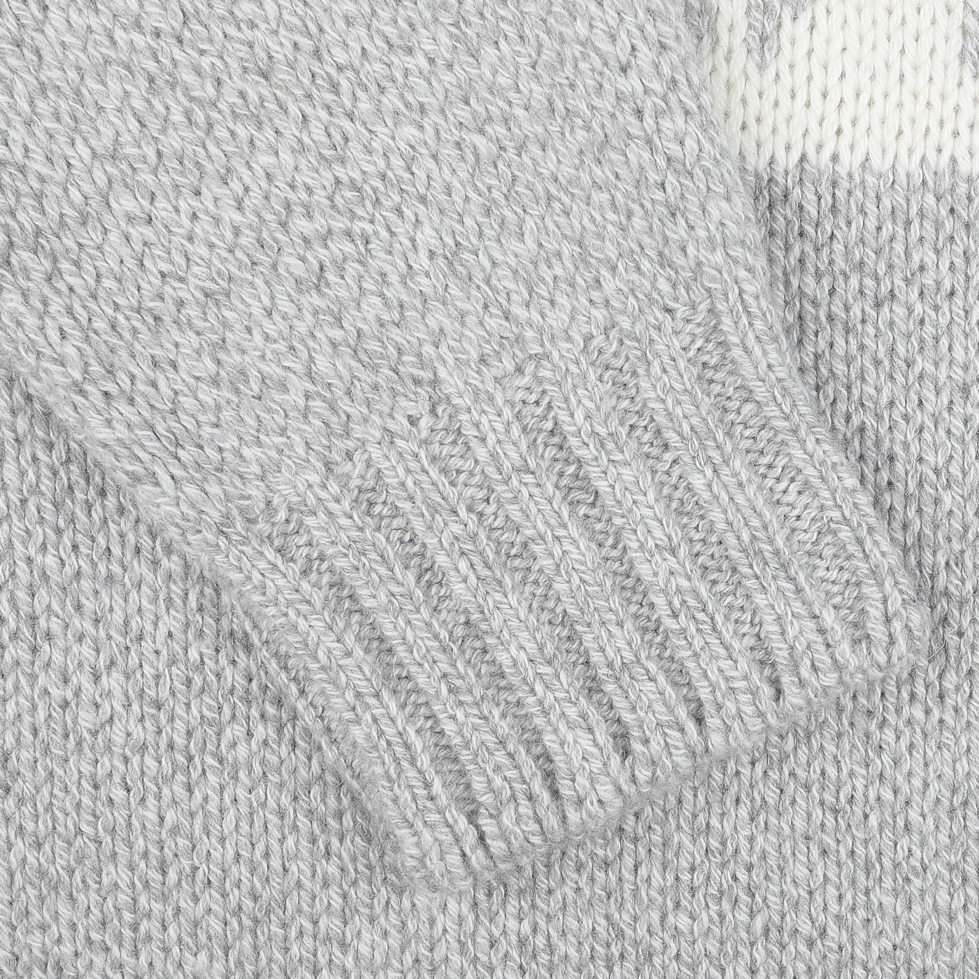 Close-up of a Grey Eco Cashmere Norwegian Crewneck Sweater by Gran Sasso, highlighting the ribbed detailing on the edge reminiscent of a classic Norwegian design.