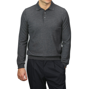 A person in a Gran Sasso Grey Extra Fine Merino Wool Polo Shirt with long sleeves and black pants stands against a plain background.