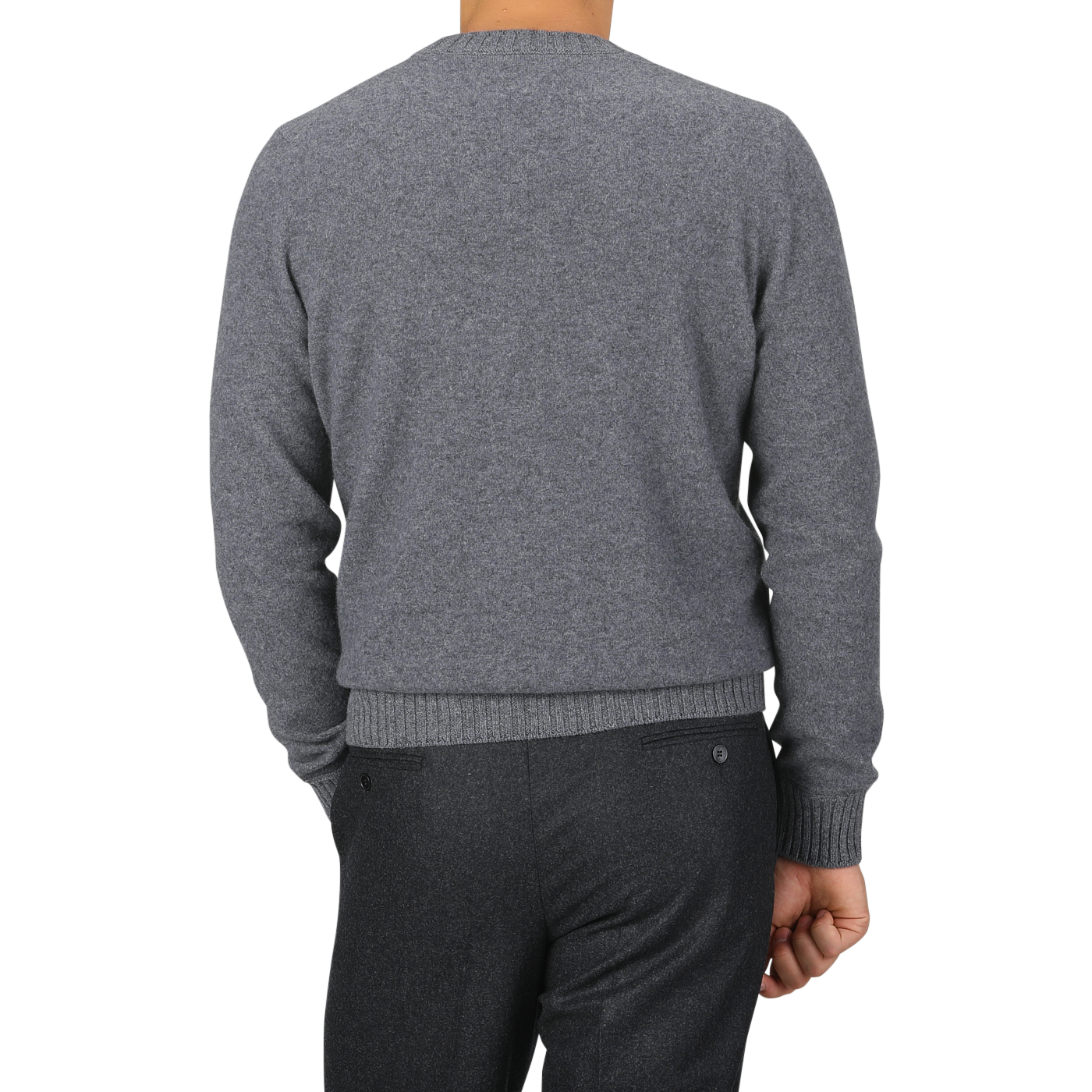 A person is shown from the back wearing a Grey Felted Cashmere Crewneck Sweater from Gran Sasso and dark grey pants, with their right hand resting on their side.