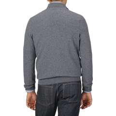 A person wearing a Grey Melange Cashmere 1/4 Zip Sweater from Gran Sasso and blue jeans is shown from the back, standing against a plain background.