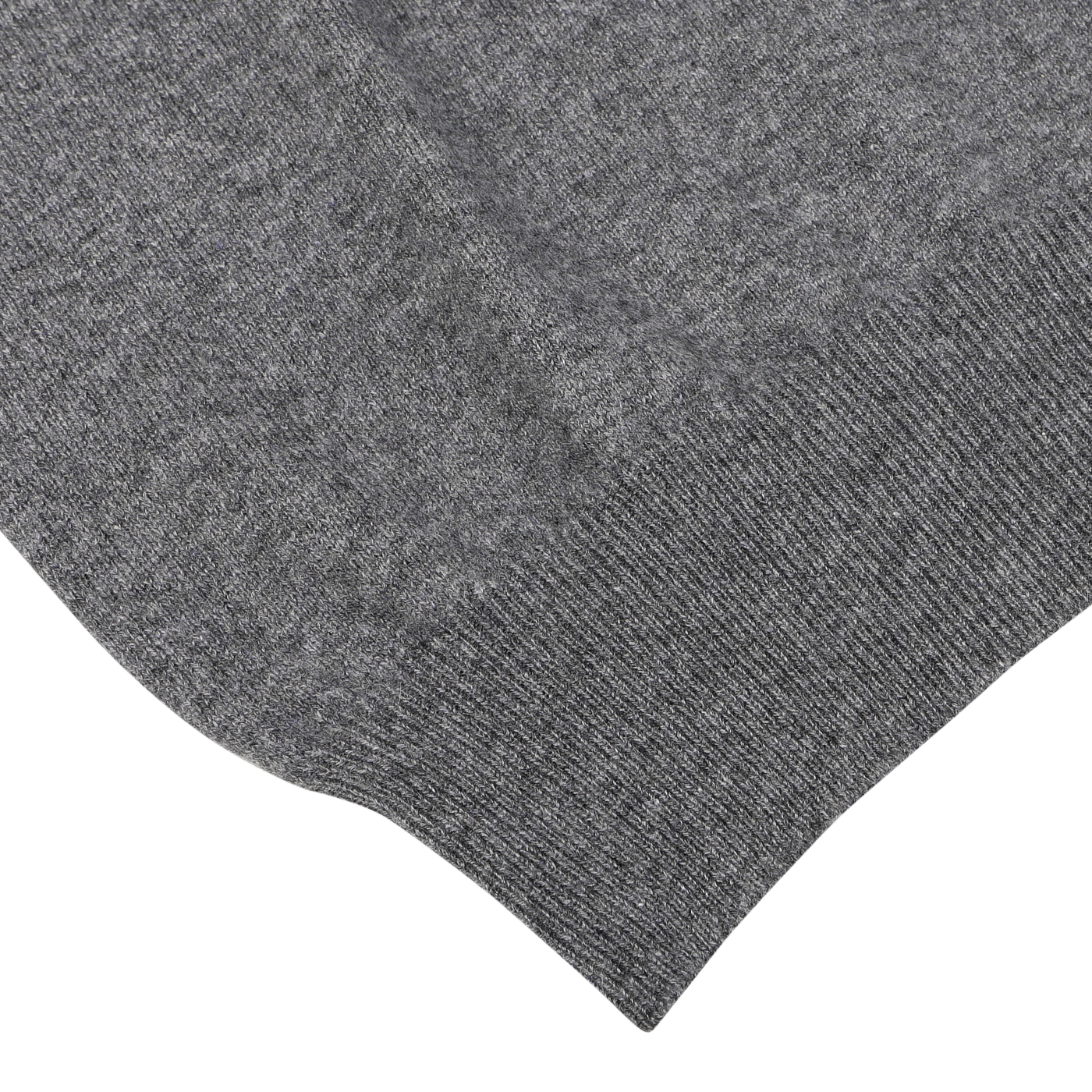 Close-up image of the corner of a Grey Melange Cashmere 1/4 Zip Sweater by Gran Sasso, showcasing its luxurious wool knitted fabric with a ribbed texture, reminiscent of premium knitwear, set against a white background.