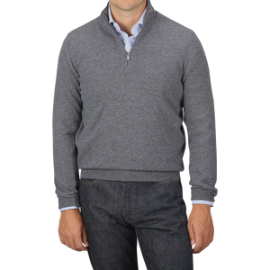 A person wearing a Gran Sasso Grey Melange Cashmere 1/4 Zip Sweater over a light blue shirt and dark jeans. Their head is not visible in the image.