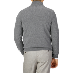 Back view of a person wearing a Gran Sasso Grey Melange Wool Cashmere 1/4 Zip Sweater and light grey pants, standing against a plain grey background.