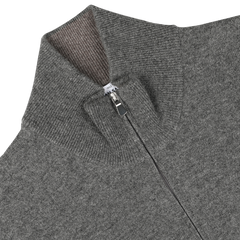 This Gran Sasso Grey Melange Wool Cashmere 1/4 Zip Sweater features a high collar with ribbing on the inside and a quarter-zip closure. A small white tag is visible at the neckline, adding a subtle touch to this piece of sustainable knitwear.