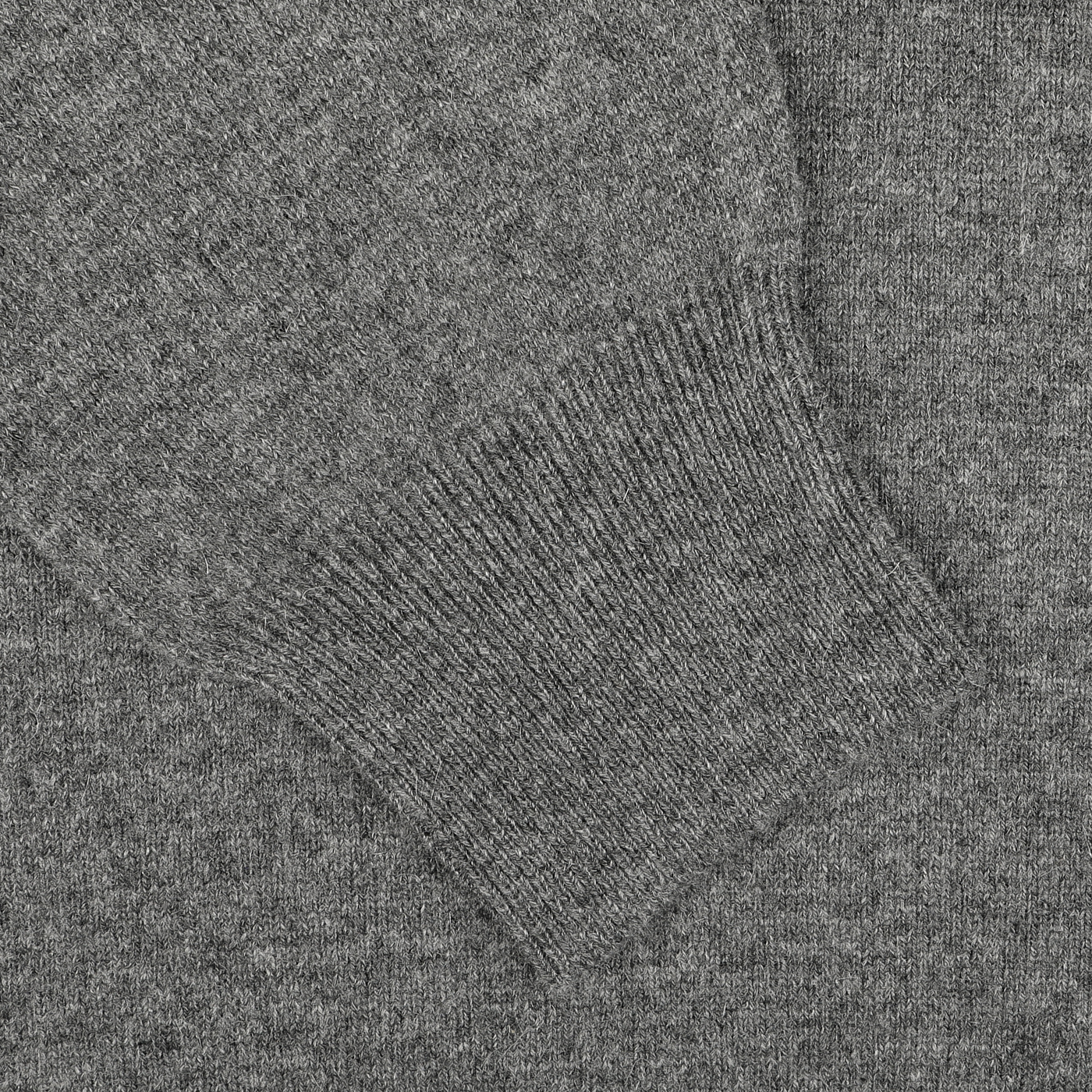 A close-up of the Grey Melange Wool Cashmere 1/4 Zip Sweater by Gran Sasso, highlighting the cuff of its sustainable knitwear sleeve.