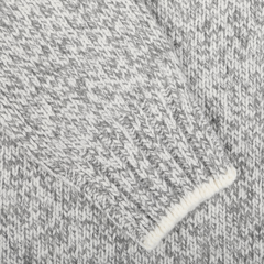 Close-up of the Grey Melange Wool Quarter Button Sweater by Gran Sasso, highlighting the texture and pattern of the pure merino wool material. The fabric appears to be part of a sleeve with ribbed cuffs, showcasing its contemporary fit.