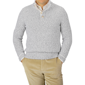 A person wearing a Gran Sasso Grey Melange Wool Quarter Button Sweater and beige corduroy pants.