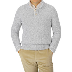 A person wearing a Gran Sasso Grey Melange Wool Quarter Button Sweater and beige corduroy pants.