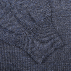 Close-up of an indigo blue Extra Fine Merino Wool Polo Shirt by Gran Sasso, highlighting the ribbed cuff and intricate texture.