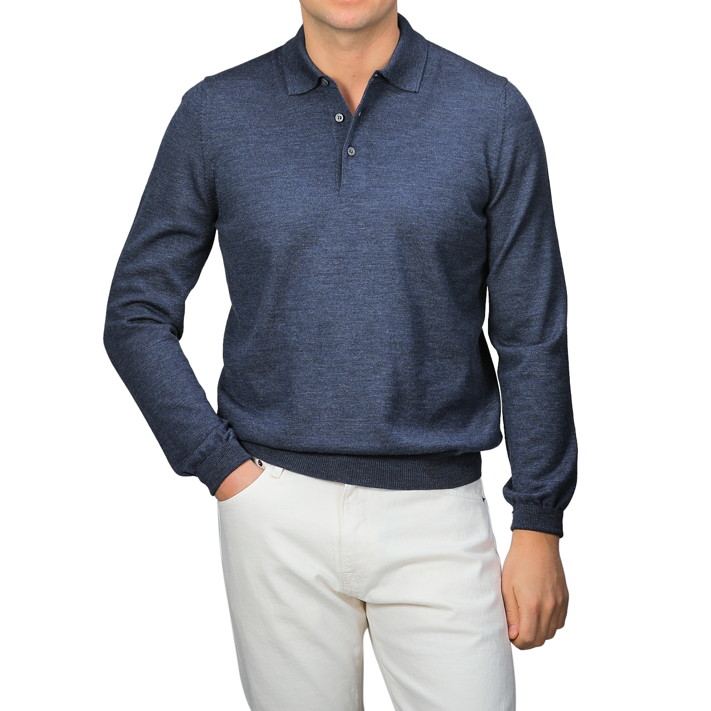 A person wearing a Gran Sasso Indigo Blue Extra Fine Merino Wool Polo Shirt and white pants stands against a gray background.