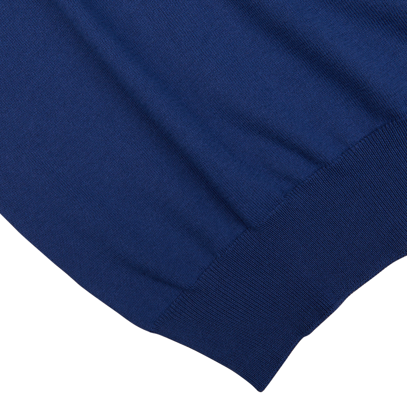 Close-up of a Gran Sasso Indigo Blue Organic Cotton LS Polo Shirt with ribbed hem detailing on a white background.