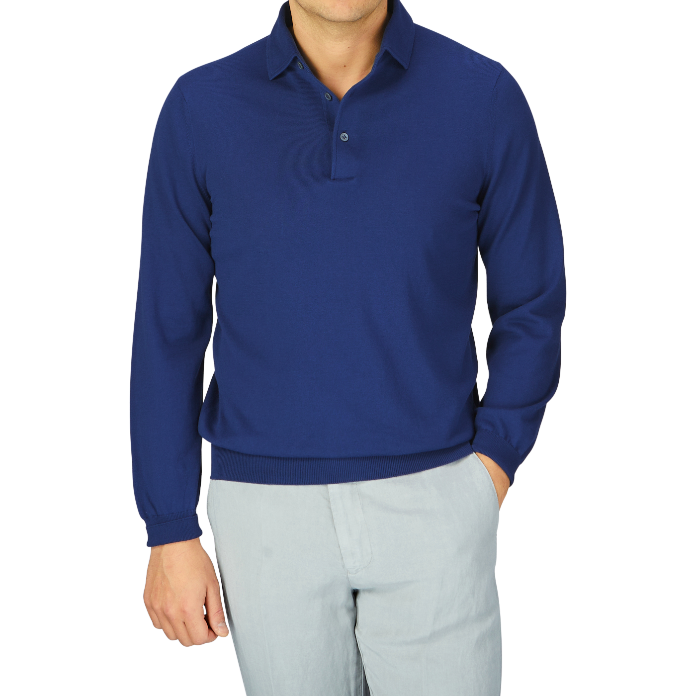 A person wearing an Indigo Blue Organic Cotton LS Gran Sasso polo shirt paired with light gray trousers.