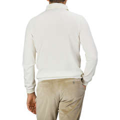 A man is wearing an Ivory Merino Wool One-Piece Collar Polo Shirt by Gran Sasso and beige corduroy pants, shown from the back.