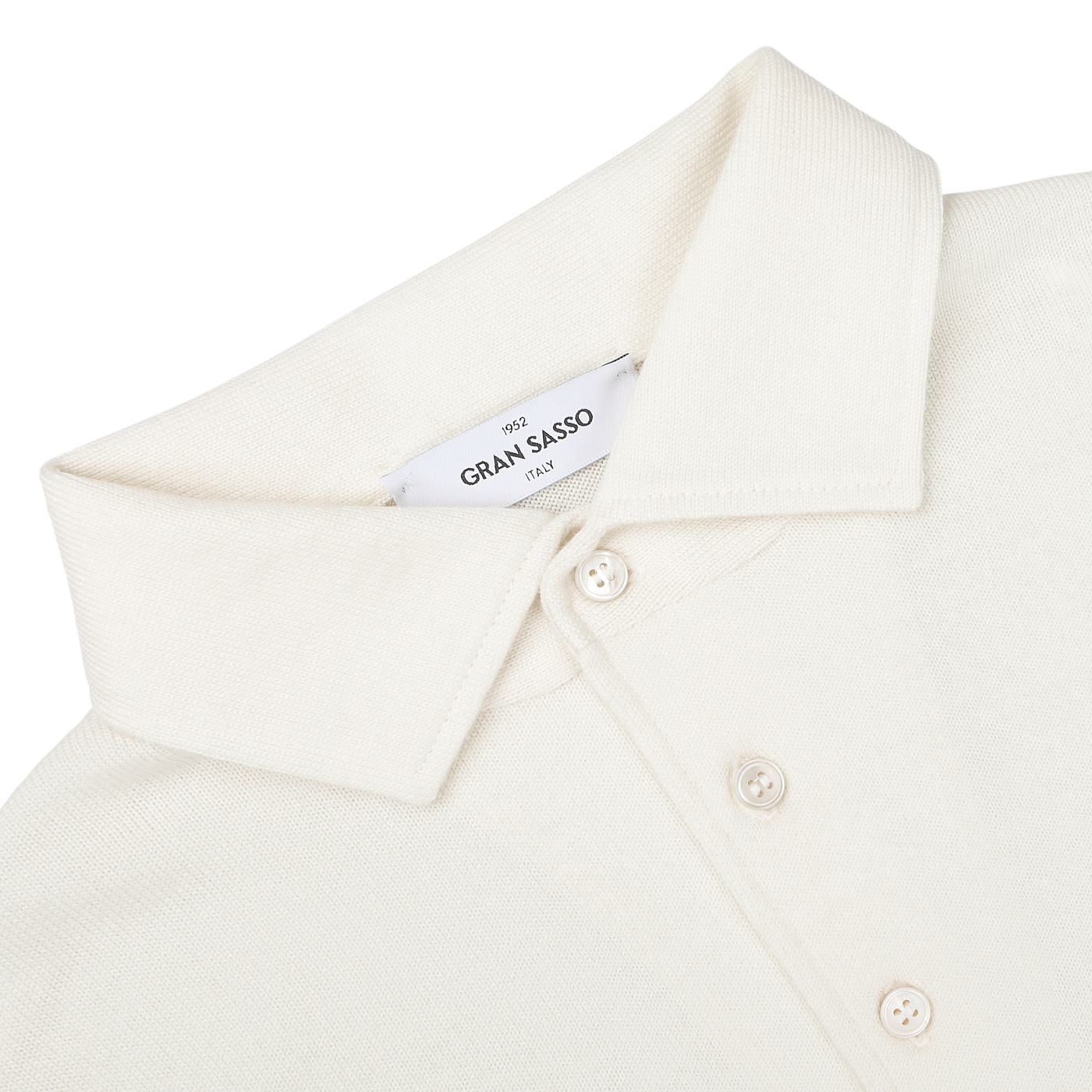 A close-up of an Ivory Merino Wool One-Piece Collar Polo Shirt with long sleeves, featuring three buttons and a 'Gran Sasso' label on the inside of the collar.