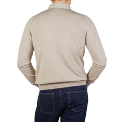 The back view of a man wearing a Gran Sasso Light Beige Merino Wool One-Piece Collar Polo Shirt and jeans.