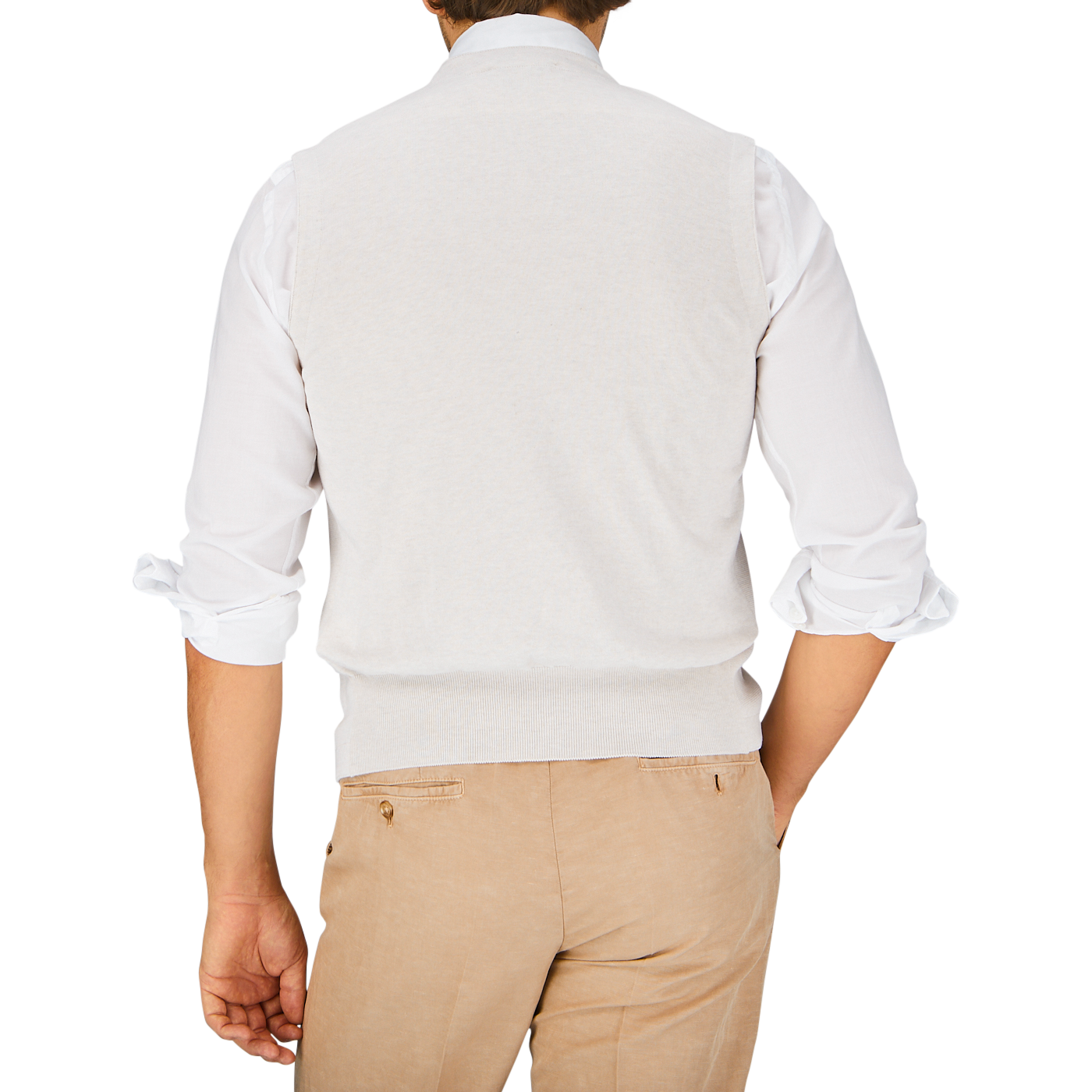 A man seen from the back wearing a white shirt from Gran Sasso and beige pants.