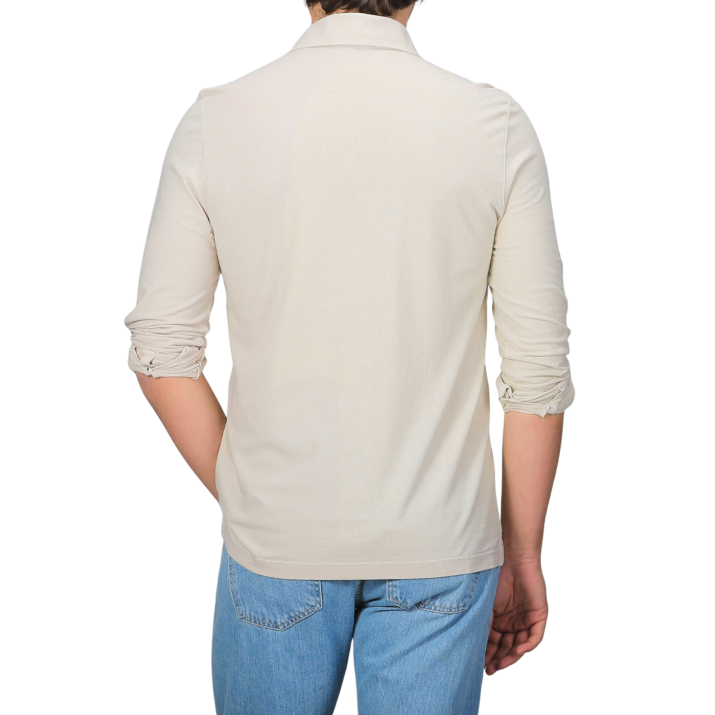 A person, back to the camera, is wearing a slim fit cream long-sleeve shirt that resembles Gran Sasso's Light Beige Washed Cotton Popover Shirt, effortlessly paired with blue jeans.