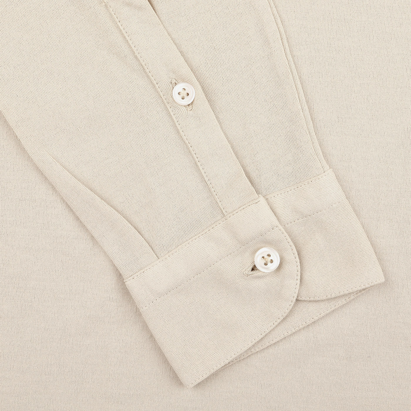 Close-up of the Gran Sasso Light Beige Washed Cotton Popover Shirt showcasing the cuff with button closure, emphasizing its slim fit elegance and a section of the sleeve.