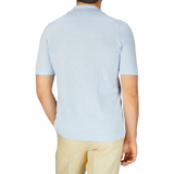 The back view of a man wearing a Gran Sasso Light Blue Linen Cotton Bowling Shirt and tan pants.