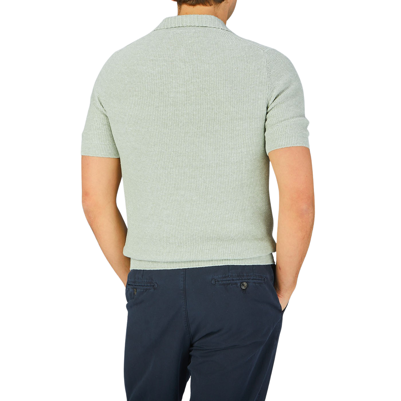 The back view of a man wearing a Gran Sasso light green cotton linen polo shirt and navy pants.
