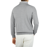 The back view of a man wearing a Light Grey Merino Wool One-Piece Collar Polo Shirt made by Gran Sasso.