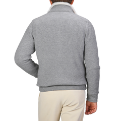 A person wearing a luxurious Gran Sasso Light Grey Faux Fur Lined Cashmere Blouson and beige pants, seen from the back, against a plain background.