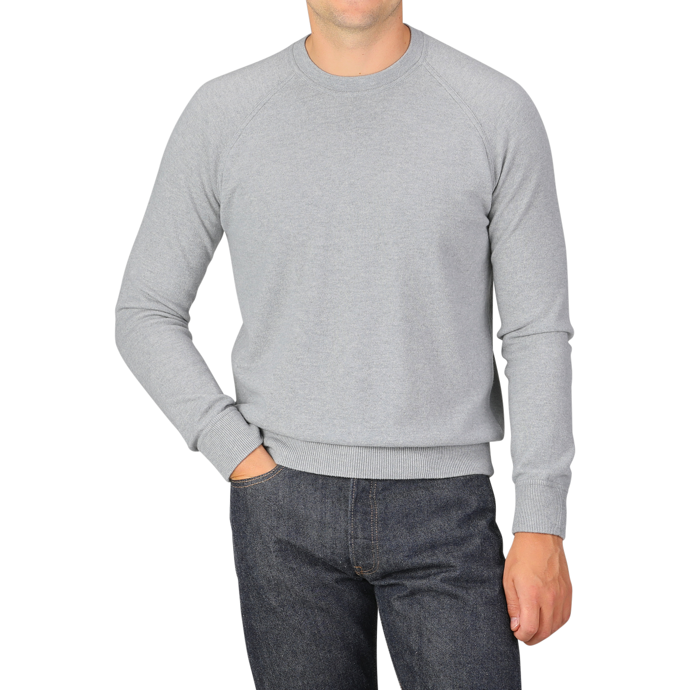 A person wearing a Light Grey Wool Cashmere College Sweater by Gran Sasso and dark jeans, standing with one hand in their pocket against a plain background.