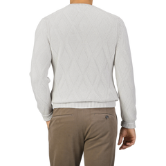 A person wearing a Gran Sasso Light Grey Wool Cashmere Diamond Knit Sweater and brown pants is shown from the back.