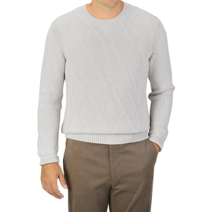 A person wearing a Light Grey Wool Cashmere Diamond Knit Sweater by Gran Sasso and brown pants. The person's head is not visible.