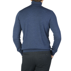 The back view of a man wearing a Gran Sasso Mid Blue Extra Fine Merino Roll Neck sweater.