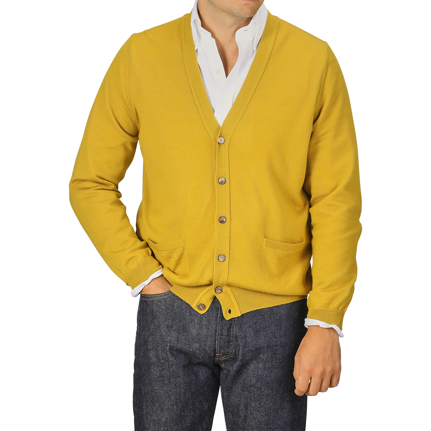 A person wearing a Gran Sasso Mustard Yellow Extra Fine Merino Cardigan, paired with a white shirt and dark jeans. The cardigan features buttons and two front pockets.