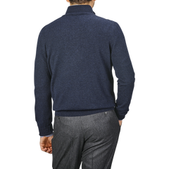 A person is seen from behind wearing a Gran Sasso Navy Blue Cashmere 1/4 Zip Sweater and gray pants against a neutral background.