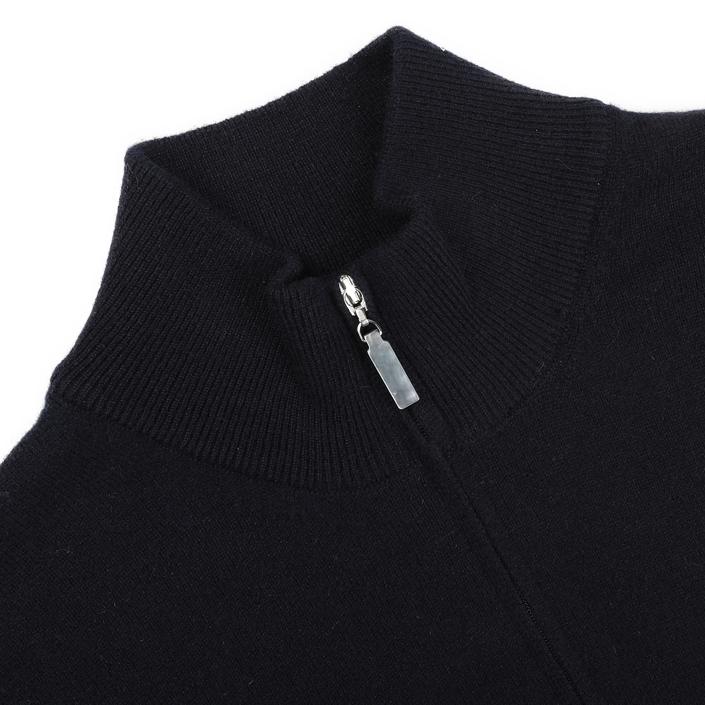 Close-up of a premium knitwear piece, this navy blue cashmere 1/4 zip sweater by Gran Sasso features a high collar and a partially unzipped silver zipper.