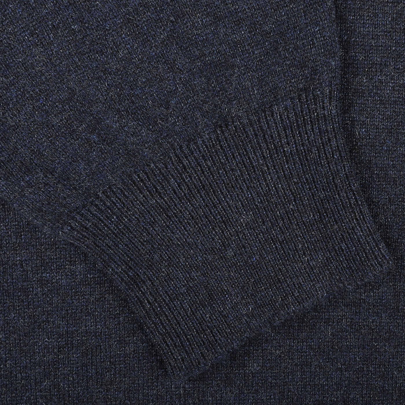 Close-up view of a navy blue cashmere sweater sleeve with ribbed cuff detail from Gran Sasso, showcasing premium knitwear quality.