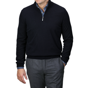 A person wearing a Gran Sasso Navy Blue Cashmere 1/4 Zip Sweater over a blue shirt with gray trousers, hands in pockets.