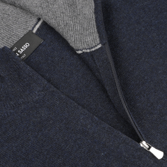 Close-up of a Navy Blue Cashmere 1/4 Zip Sweater by Gran Sasso with a visible brand label inside. The zipper is partially open, revealing the sweater's gray inner lining. This piece epitomizes premium knitwear quality.