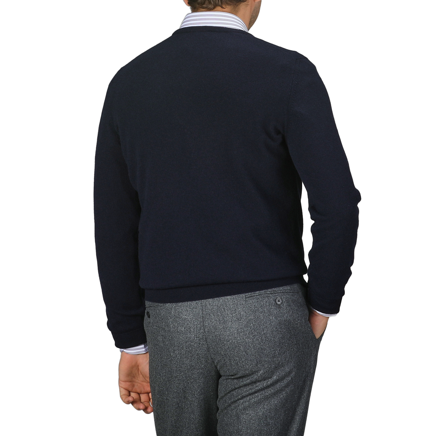 A person is depicted from the back against a plain background, wearing Gran Sasso's Navy Blue Cashmere Crewneck Sweater and gray pants, showcasing the timeless elegance of their knitwear.