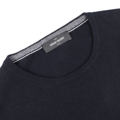 Close-up of a Navy Blue Cashmere Crewneck Sweater by Gran Sasso, featuring a label that reads "MADE IN ITALY," showcasing the exquisite craftsmanship of cashmere knitwear.