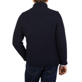 The back view of a man wearing a Gran Sasso navy blue chunky knitted wool cardigan.