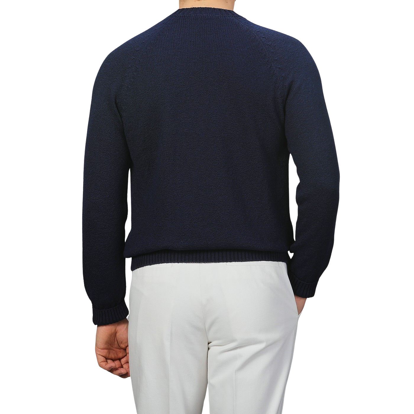 A person faces away against a gray backdrop, wearing a Gran Sasso Navy Blue Cotton Boucle Crewneck Sweater in a regular fit with white pants.