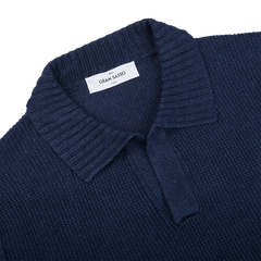 A close up of a Gran Sasso navy blue cotton linen polo shirt in a slim fit.