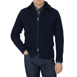 A man wearing a Gran Sasso Navy Blue Eco Cashmere Funnel Neck Cardigan and jeans.