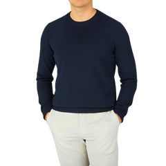 A man wearing a Navy Blue Egyptian Cotton Crewneck Sweater by Gran Sasso.