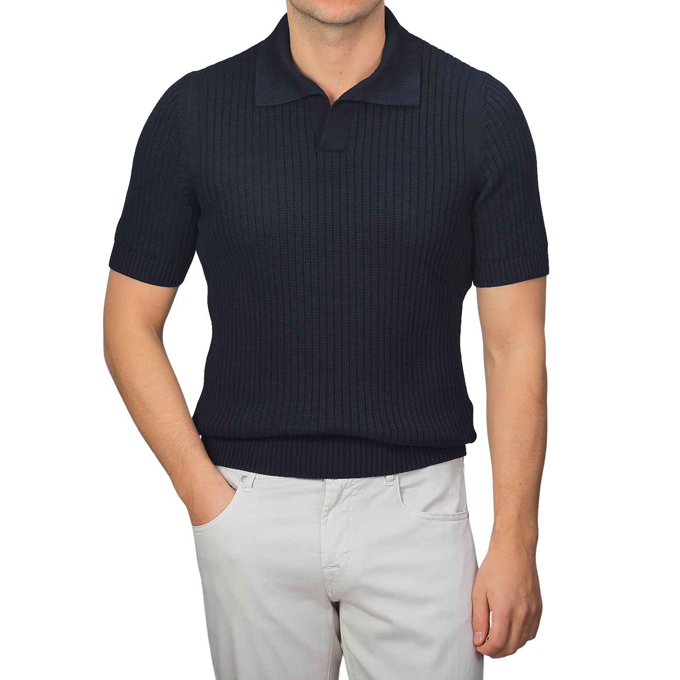 Person wearing a navy blue chunky-knit Gran Sasso polo shirt made of organic cotton and light gray pants against a plain background.