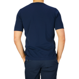 Man wearing a Gran Sasso navy blue organic cotton t-shirt and pants, viewed from the back.