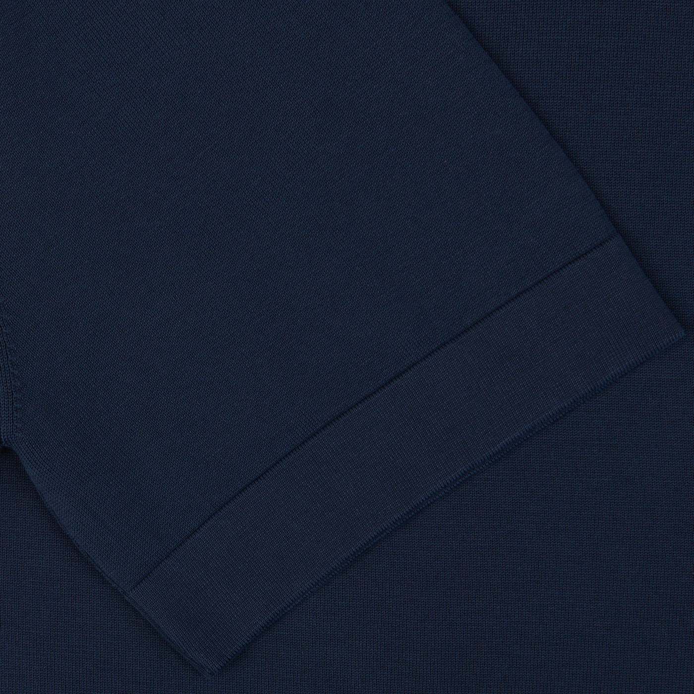 Close-up view of a Gran Sasso navy blue knitted textile with a visible hem seam.