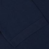 Close-up view of a Gran Sasso navy blue knitted textile with a visible hem seam.